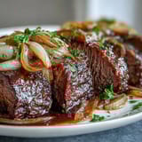 Slow-cooked Savory Crock Pot French Onion Pot Roast served over creamy mashed potatoes.