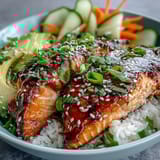 2. Quick and vibrant teriyaki salmon bowl featuring tender glazed salmon, crisp vegetables, and fluffy rice, topped with scallions and sesame.  
