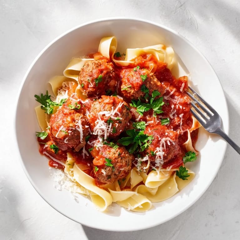 Hearty turkey meatballs topped with Parmesan cheese, paired with a simple side salad for a complete Italian-American family dinner.