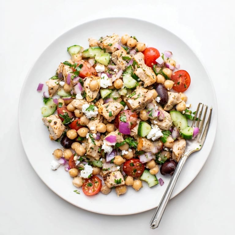 Freshly tossed Mediterranean Chickpea Chicken Salad featuring briny olives, chickpeas, and a zesty lemon-herb dressing.