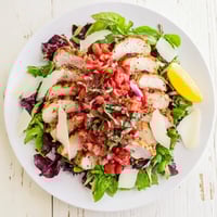 Sliced grilled chicken atop mixed greens, finished with a fresh bruschetta chicken salad topping of tomatoes, basil, and balsamic.