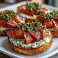 Smoked salmon bagel board with silky salmon slices, fresh bagels, and vibrant veggies for a festive Mother's Day brunch.